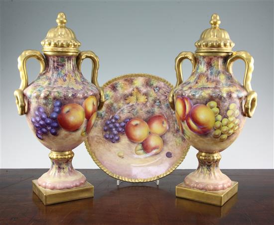 G. Delaney. A pair of fruit painted two handled Limoges porcelain vases and covers, late 20th century, 27cm